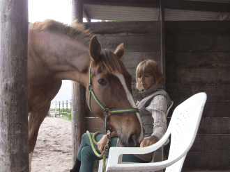 Mary pointing to chair